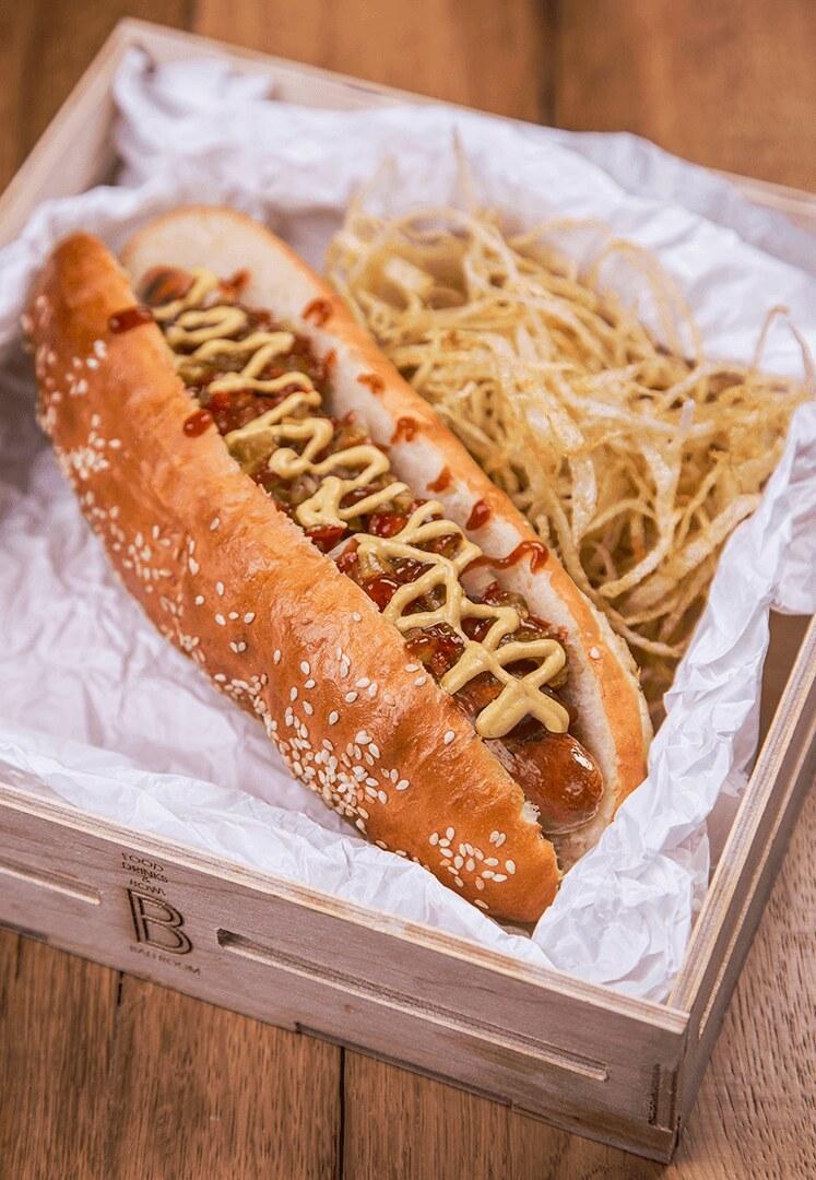 A hot dog served in a branded wooden box